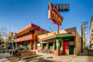 The Cherry Cricket restaurant at 2nd & Clayton has been operating since 1954 and features a large neon sign.